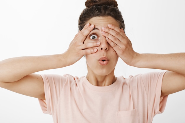 Free photo close-up of carefree intrigued girl posing against the white wall