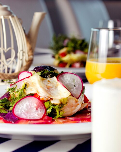 Close up of carpaccio plate served with orange juice