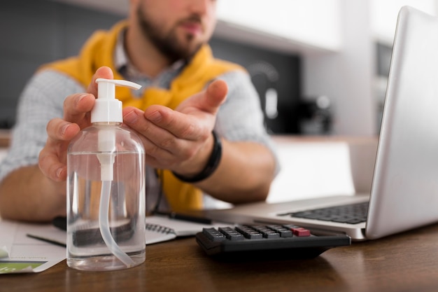 Close-up casual male disinfecting hands