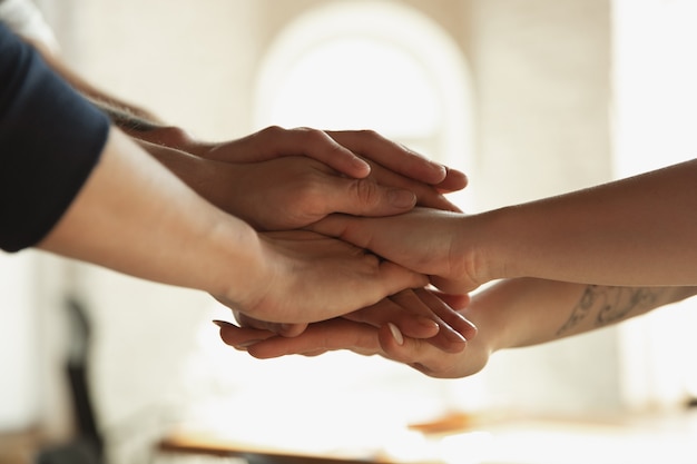 Free photo close up of caucasian male and female hands, covering one another, shaking. concept of business, finance, job. copyspace