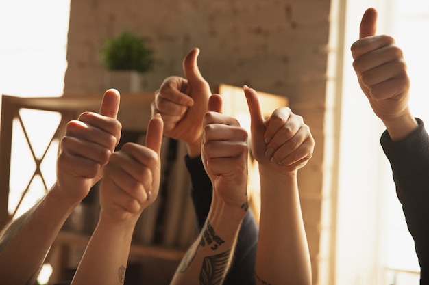 Close up of caucasian male and female hands showing nice, thumbs up