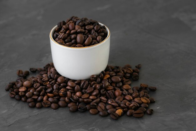 Close-up ceramic cup filled with coffee beans