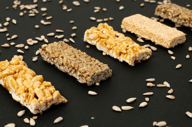 Close-up cereal bars and sunflower seeds on plain background