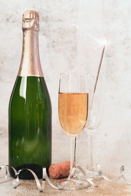 Close-up champagne bottle with glasses