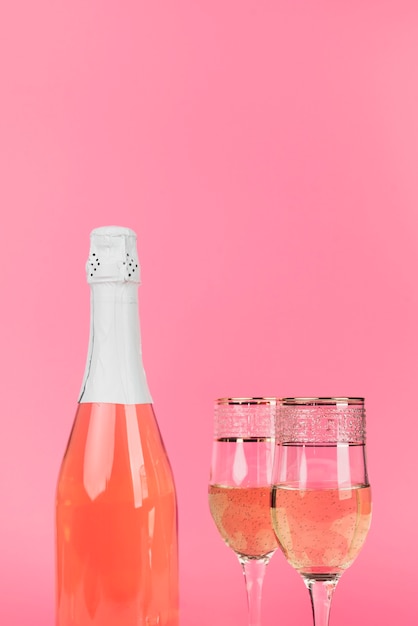 Close-up champagne bottle with glasses