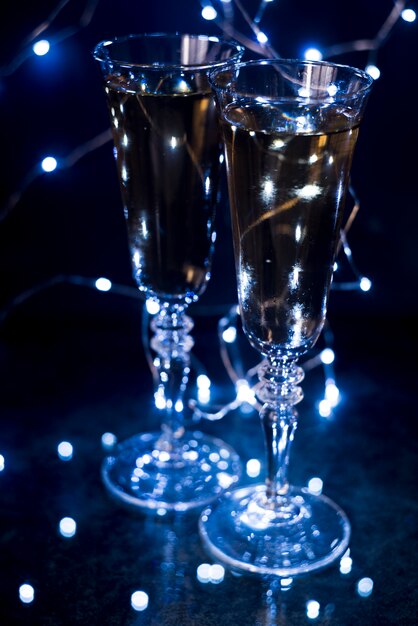 Close-up of champagne glasses in illuminated night club