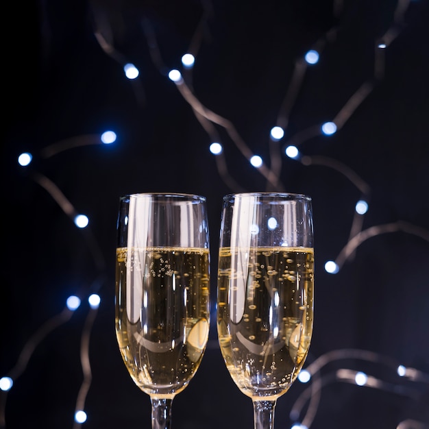 Close-up of champagne glasses at illuminated nightclub