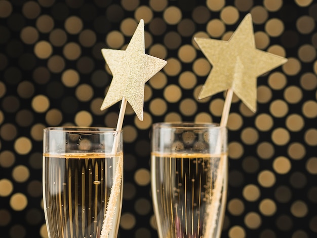 Close-up of champagne glasses with golden stars