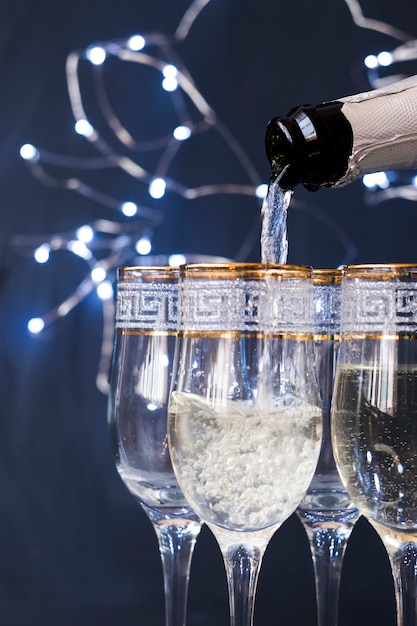 Close-up of champagne pouring into the glass at night