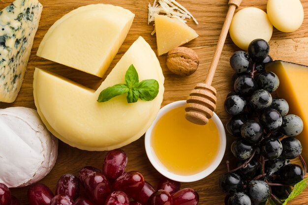 Close-up cheese grapes and honey