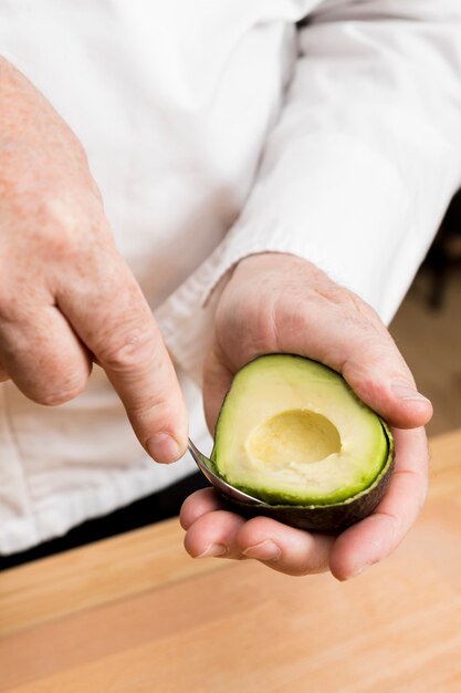 Close-up chef cooking avocado