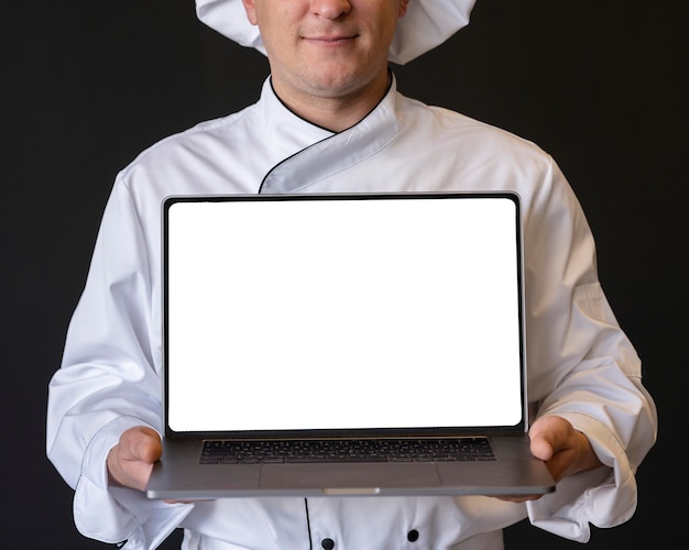 Close-up chef holding laptop