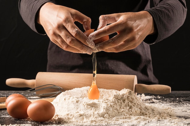 Close-up chef pouring egg on flour