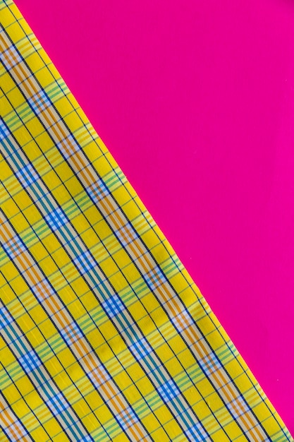 Close-up of chequered pattern textile on pink background