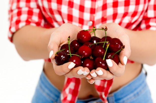 Free photo close up of cherry in woman's hands.