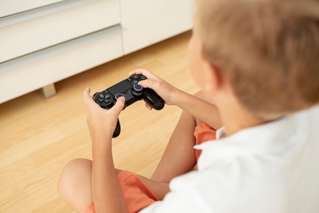 Close-up child holding a controller