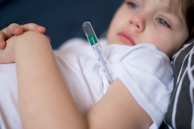 Close-up child and thermometer