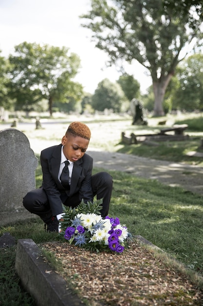 Close up on child visiting the grave of loved one