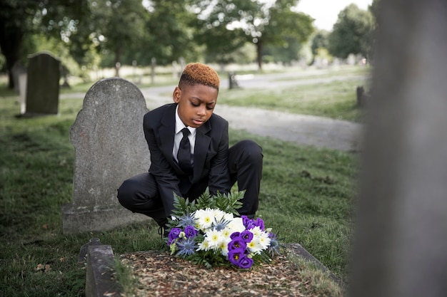 Free photo close up on child visiting the grave of loved one