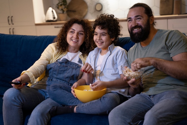 Close up on child watching movies with parents