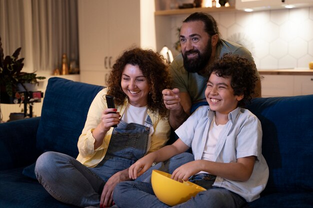 Close up on child watching movies with parents