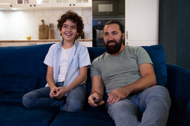 Close up on child watching movies with parents