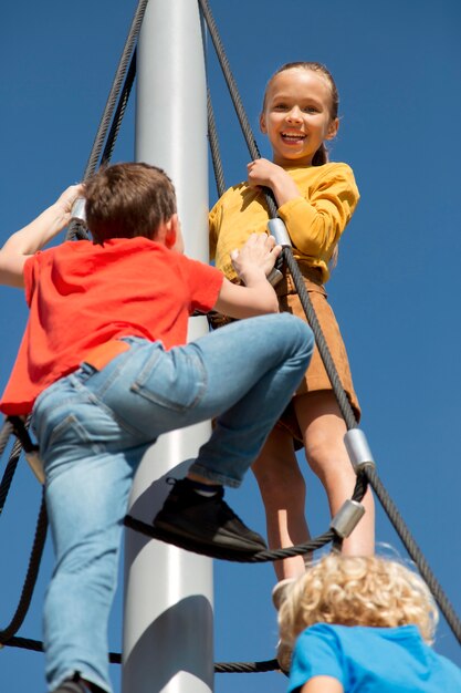 Close up children climbing rope