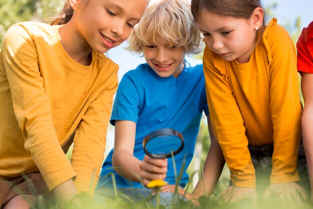 Close up children with magnifying glass