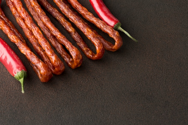 Close-up chili peppers with pork sausages