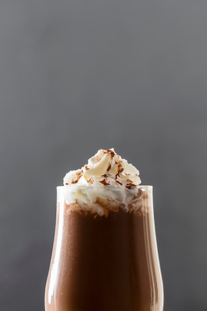 Close-up of chocolate milkshake with cream