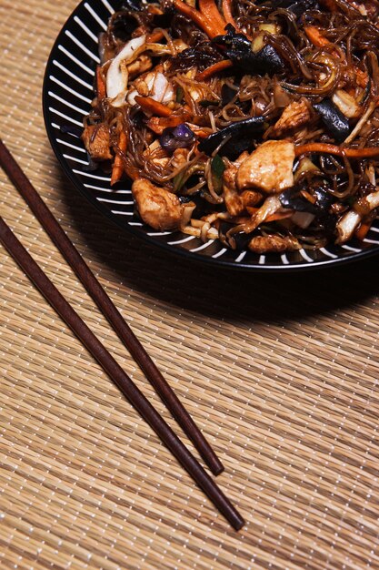 Close-up chopsticks near Asian food