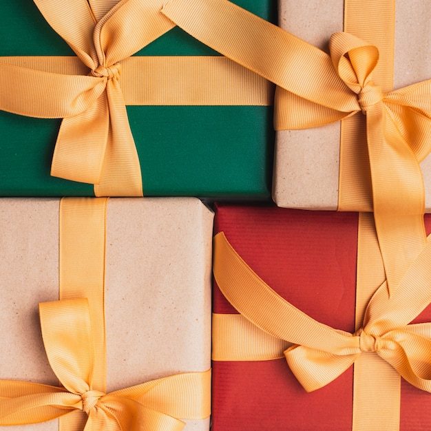 Close-up of christmas gifts with golden ribbon