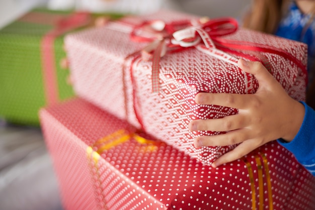 Крупным планом рождественские подарки в руках ребенка