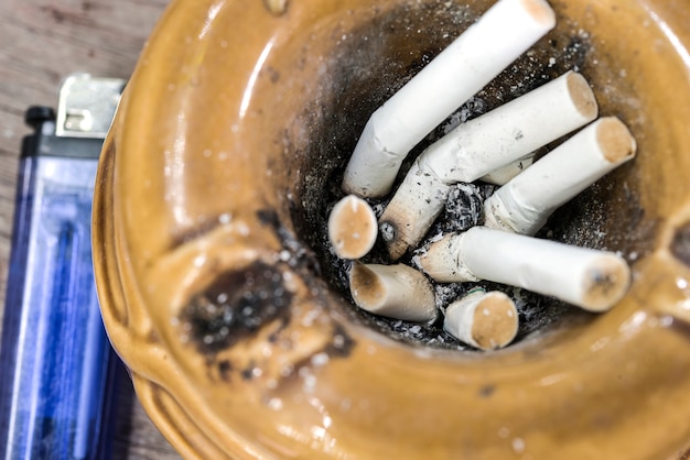 Close up cigarette butts stuck in ash