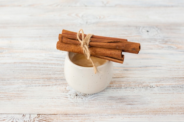 Free photo close-up cinnamon sticks on top of cup