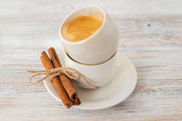 Close-up cinnamon sticks with coffee cups