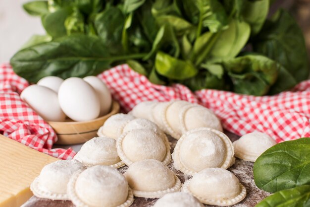 Close-up of circular raw ravioli with spinach and eggs