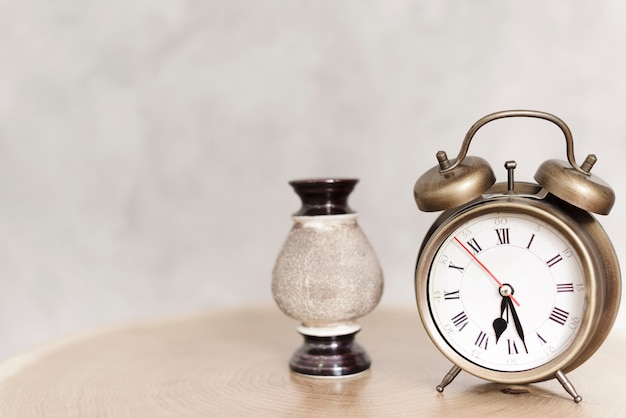 Close-up clasic alarm clock on nightstand