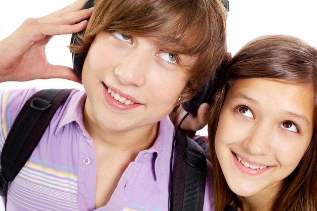 Close-up of classmates listening to music