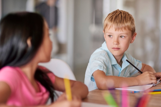 Close up of classmates sitting at desk