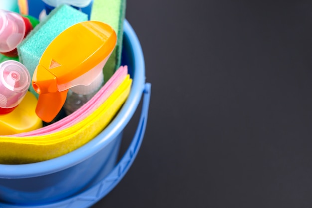 Close-up of cleaning equipments in basket over black background