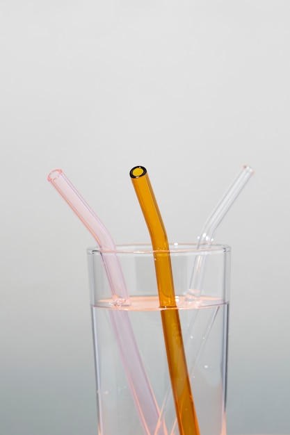 Free photo close- up of clear glass straws in transparent liquid