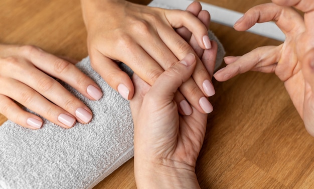 Free photo close up client getting manicure