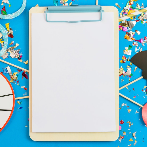 Close-up clipboard on confetti