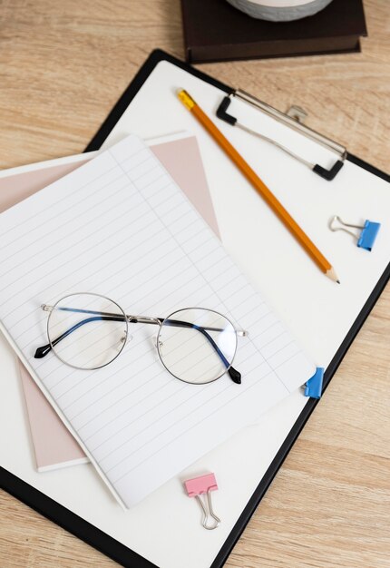 Close up clipboard and glasses