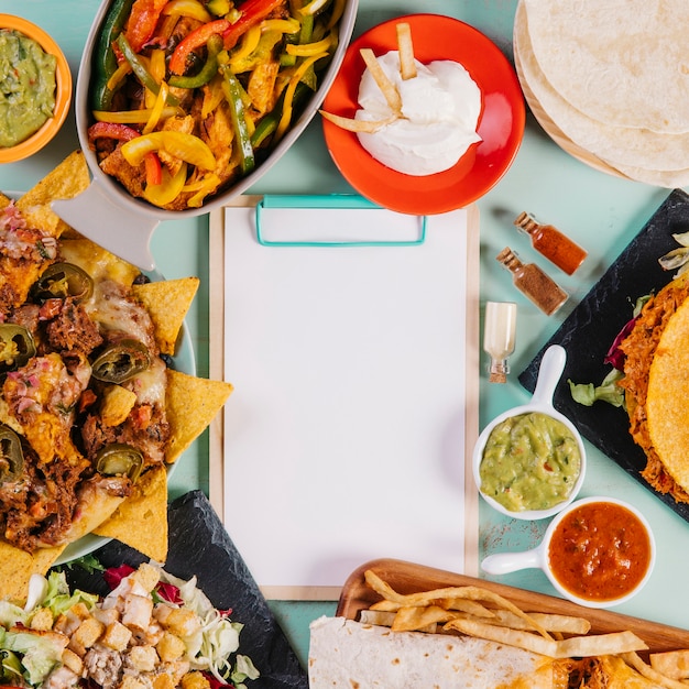 Close-up clipboard and mexican dishes