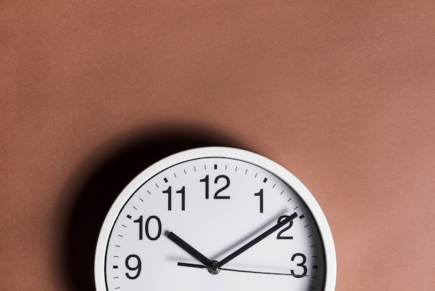 Close-up of clock against brown background