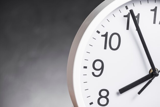 Close-up of clock face against gray background