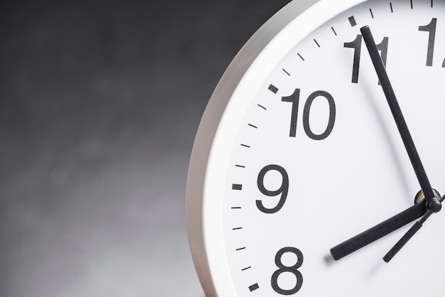 Close-up of clock face against gray background