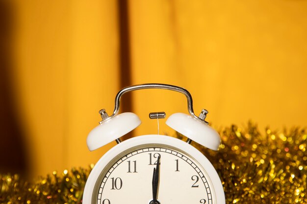 Close-up clock with golden decorations behind